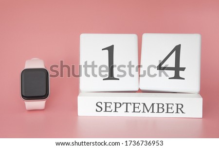 Modern Watch with cube calendar and date 14 september on pink background. Concept autumn time vacation.