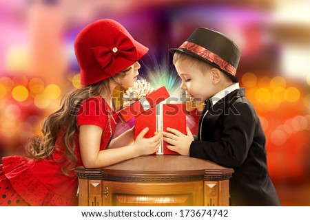 Happy children opening magic gift. Present for a birthday, valentine's day or other holiday