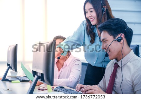 Group of young teamwork  businesspeople with headset and computer at office. Business assistance concept.