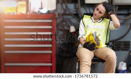 factory worker sitting on chair and suffering stress fail at factory workshop equipment. Royalty-Free Stock Photo #1736781572