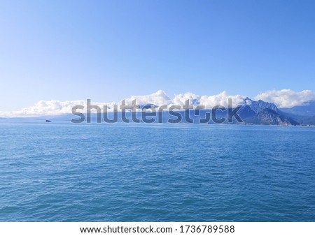 pictures showing the blue cloudy sky and blue water sea in winter 