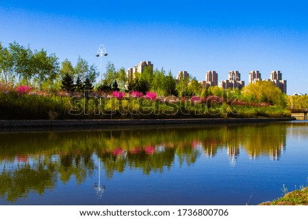 Spring colors and modern buildings reflected in the lake