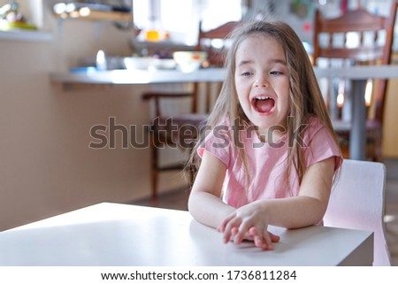 little girl with their mouths wide open. The child are playing. the concept of education , childhood, emotions, dentistry, surprise, friendship. Copy space
