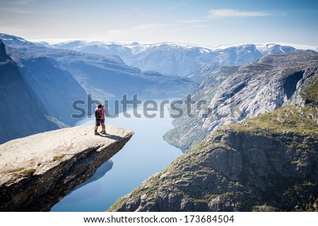 couple on trolltunga in norway  Royalty-Free Stock Photo #173684504
