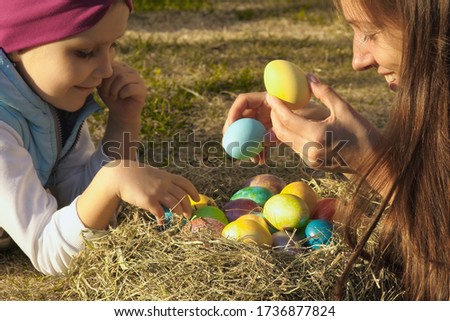 Mother with daughter with easter eggs
