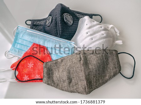 COVID-19 mask wearing: Different types of face masks protection for coronavirus prevention: reusable homemade cloth wear, disposable medical mask, n95 respirator. Royalty-Free Stock Photo #1736881379