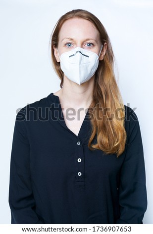 white woman wearing a KN95 FPP2 face mask Covid-19 Royalty-Free Stock Photo #1736907653