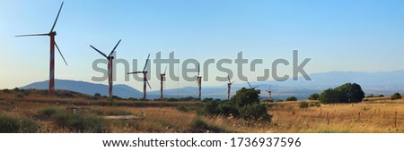Wind generators in the Golan Heights, Israel. Panorama. Royalty-Free Stock Photo #1736937596