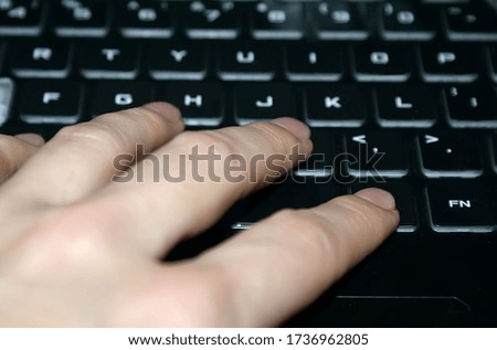 a woman's hand on a computer keyboard. working in the office at the computer