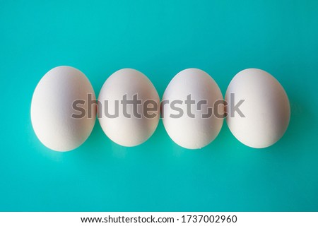 Chicken eggs on blue background