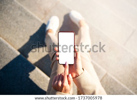 Woman using mobile phone in the city, screen mockup for your app design