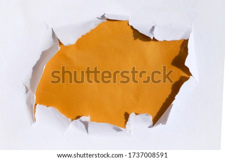 A hole in paper with a gold background below. Template for text on a banner. Breakthrough white paper hole Gold 