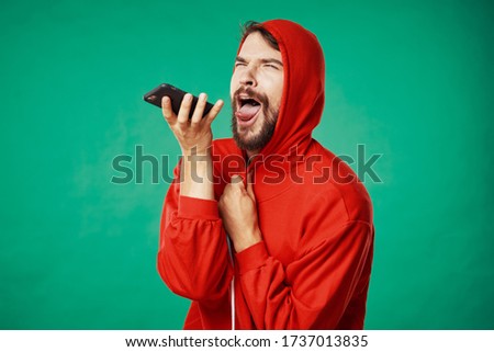 Green background man mobile phone red sweater