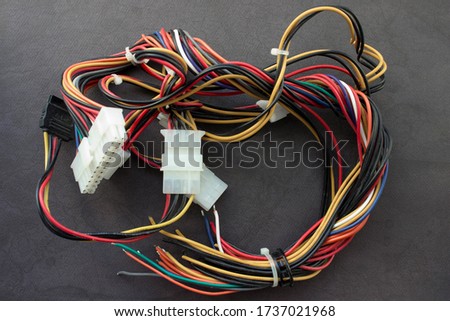 Multi-colored wires from a desktop computer. Wires leading electricity to individual PC components.