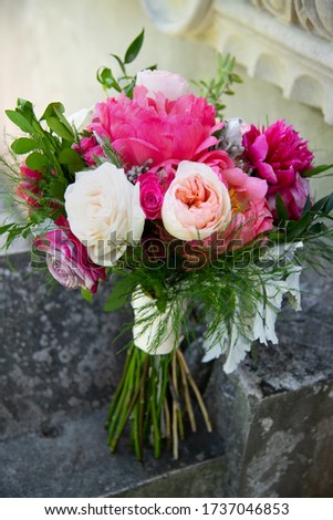 Wedding bouquet of red, white and pink  peonies. bridal bouquet of pink peonies. Beautiful bridal bouquet