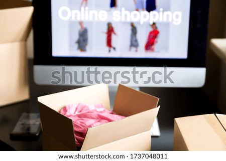 Box with clothes. Computer screen.