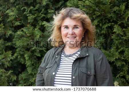 senior smiling woman in park, happy retirement