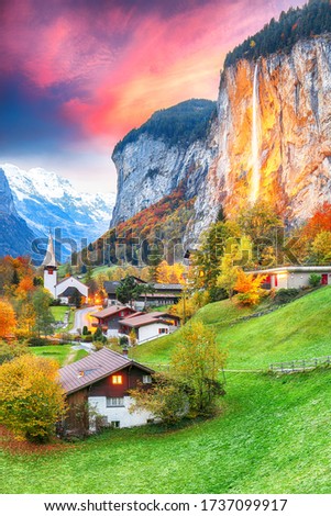 Captivating autumn view of Lauterbrunnen valley with gorgeous Staubbach waterfall and Swiss Alps at sunset time.  Location: Lauterbrunnen village, Berner Oberland, Switzerland, Europe. Royalty-Free Stock Photo #1737099917