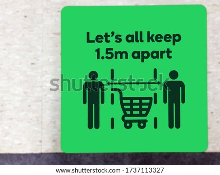 COVID-19 pandemic social distancing rule -Lets all keep 1.5m apart sign in supermarket.