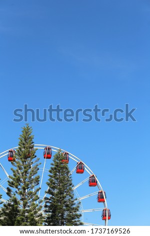 Ferris wheel on the background of the blue sky.