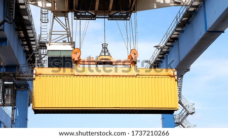 Shipping Container loaded by a Gantry crane onto a large Container Ship.