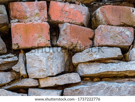 Stone texture background, copy space. Detail of stone abstract background, free space. Decorative uneven cracked stone wall surface. red brick.