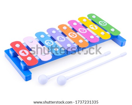 Bright toy xylophone isolated on a white background, close-up. Children's musical instruments. Development of musical hearing in a child. Creative development of children from an early age.