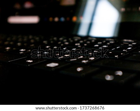 Modern black laptop keyboard closeup.