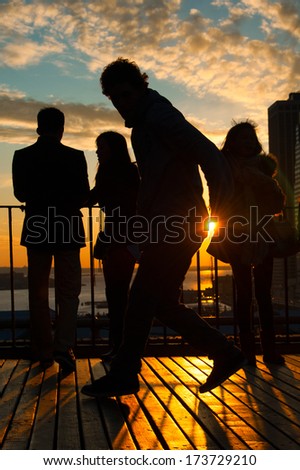 Man dancing on terrace at sunset, Midtown, Manhattan, New York City, New York State, USA