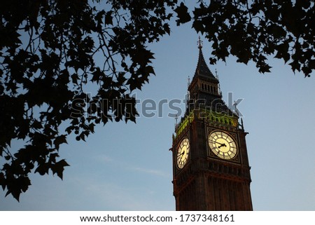 Big Ben and the Elizabeth Tower can be seen through the trees, Stock Photo. City of Westminster - London, England