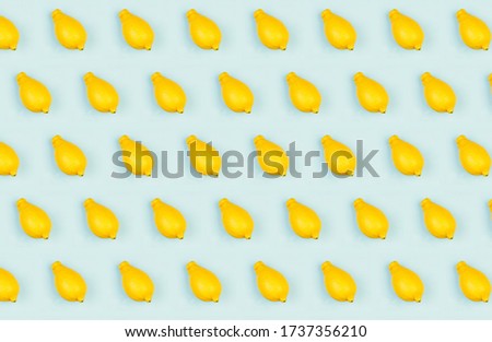Fresh lemons pattern a blue background flat lay, concept of healthy eating, raw food diet and vegetarianism