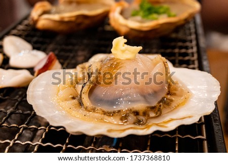 Butter firing of the scallop on a hot grill