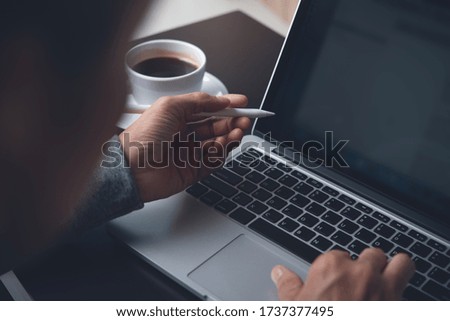 Close up of business man hands with stylus pen typing on laptop computer keyboard browsing internet, Web designer working on laptop, online working, e business, wireless network communication concept