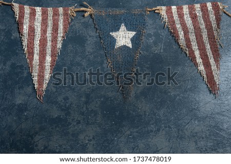 Rustic star and strips banner on a blue gray textured background.