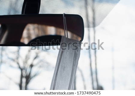 protective mask on the rearview mirror