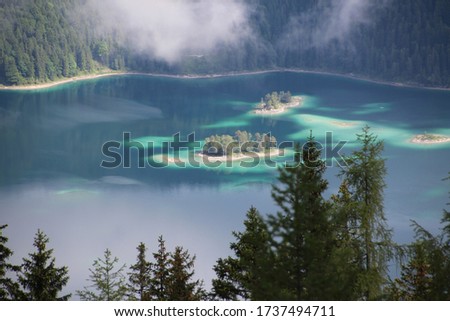 Lake with an island and a cloud