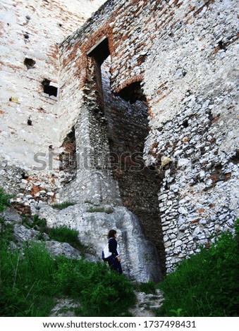 Tourist exploring th ruins of the old castle in Olsztyn, Poland.
