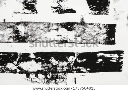 macro photo of black lino ink remain, linocutting paint roller texture on white paper background. Royalty-Free Stock Photo #1737504815