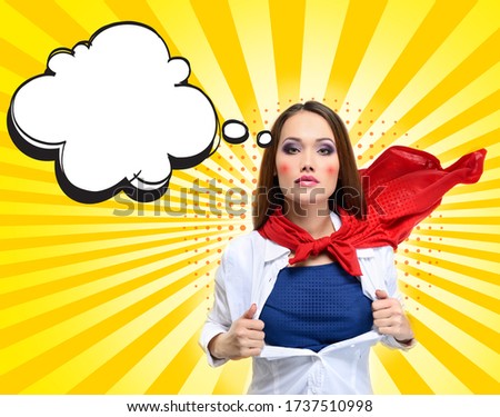 Pop Art style of Superwoman with speech bubbles and halftone dots design, creative collage. Young pretty woman opens her shirt like a superhero. Super girl over bright sunbeams yellow background. Royalty-Free Stock Photo #1737510998