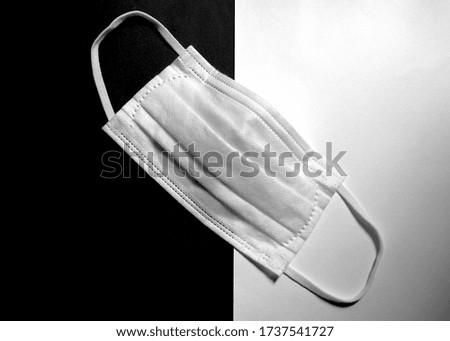 Surgical mask on black and white background,medical protective mask during Corona virus (COVID-19) pandemic,health care and medical concept.