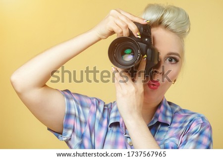 A photo of the pin-up girl with a photo camera
