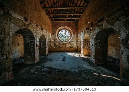 Round stained glass window in old abandoned castle Royalty-Free Stock Photo #1737584513