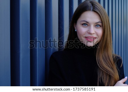 portrait of a beautiful young girl with natural makeup on the street