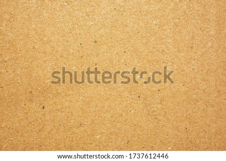 The surface of the brown cardboard is used for the background.