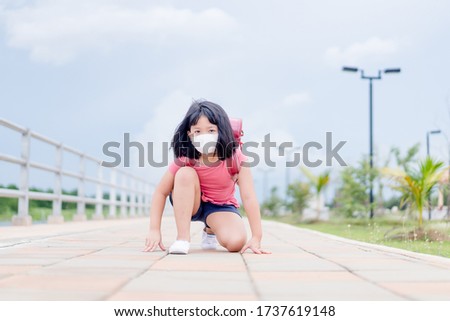 Asian kid girl student wearing face mask.Determined young girl ready for go to school.Reopen school from lockdown. Back to school. Covid-19 coronavirus pandemic.New normal lifestyle.Education concept Royalty-Free Stock Photo #1737619148