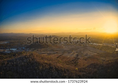 This unique photo shows the autumnal hilly landscape of hua hin in thailand, taken with a drone by the evening sun during a wonderful sunset! In this picture you can also see the golden evening sky!