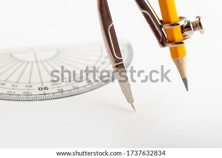 compass for drawing and drafting isolated with pencil on the white desk