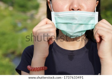 The woman wear the face mask wrong. Wearing a face mask won't protect from contracting COVID-19