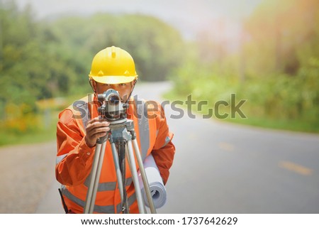 Surveyor engineer worker making measuring with theodolite on road works.survey engineer in construction site.