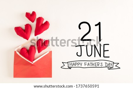 Father's Day message with red heart cushions coming out of an envelope